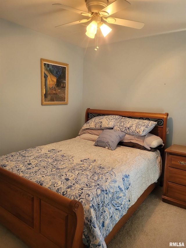 bedroom with a ceiling fan and light colored carpet