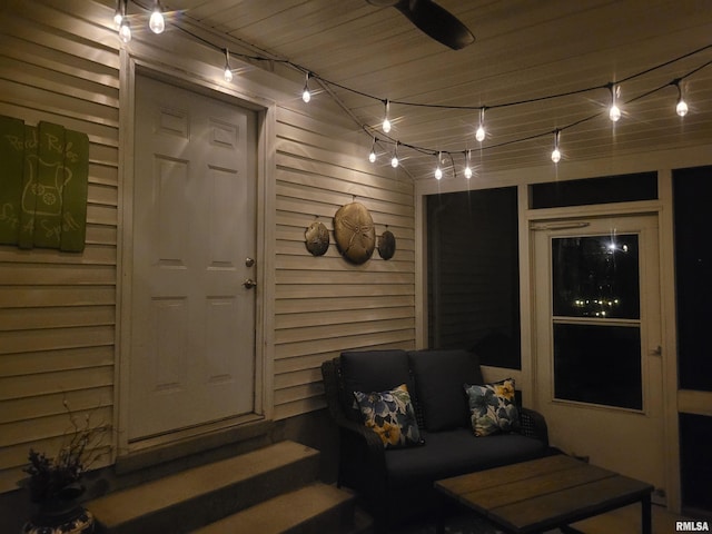 exterior entry at night featuring ceiling fan