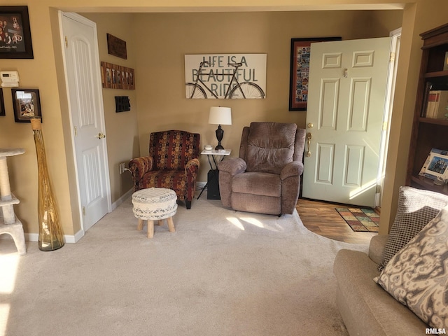 sitting room featuring carpet and baseboards