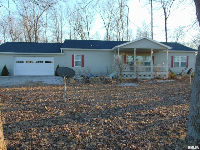 view of front of property featuring a porch, driveway, and a garage