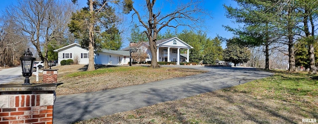 greek revival inspired property featuring driveway