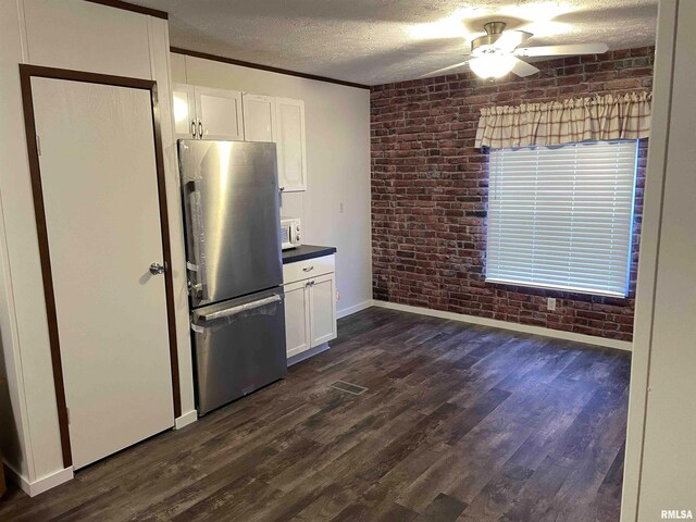 24555 Rock Springs Hollow Rd, Thebes, IL 62990 - kitchen featuring freestanding refrigerator, brick wall, a ceiling fan, baseboards, and white cabinets