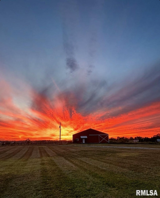 yard at dusk with a rural view and an outbuilding