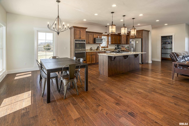 kitchen featuring dark wood-style floors, a kitchen island, appliances with stainless steel finishes, and recessed lighting