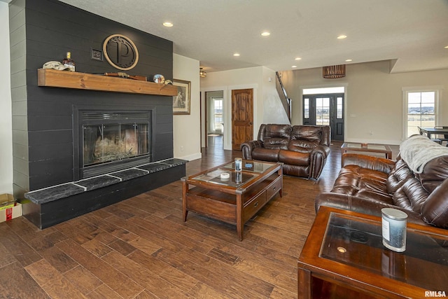 living room with a fireplace, baseboards, wood finished floors, and recessed lighting