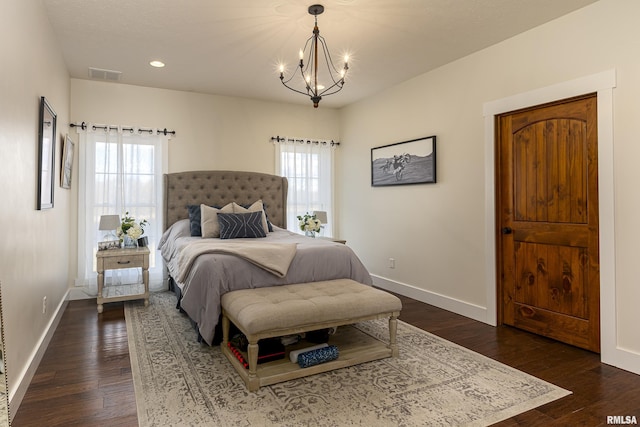 bedroom featuring dark wood-type flooring, multiple windows, visible vents, and baseboards