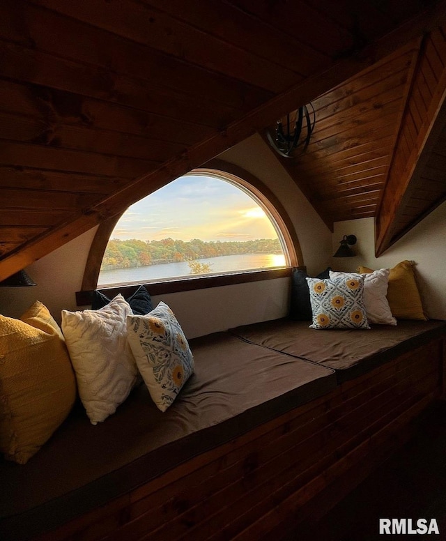 bedroom featuring wood ceiling, a water view, and vaulted ceiling with beams