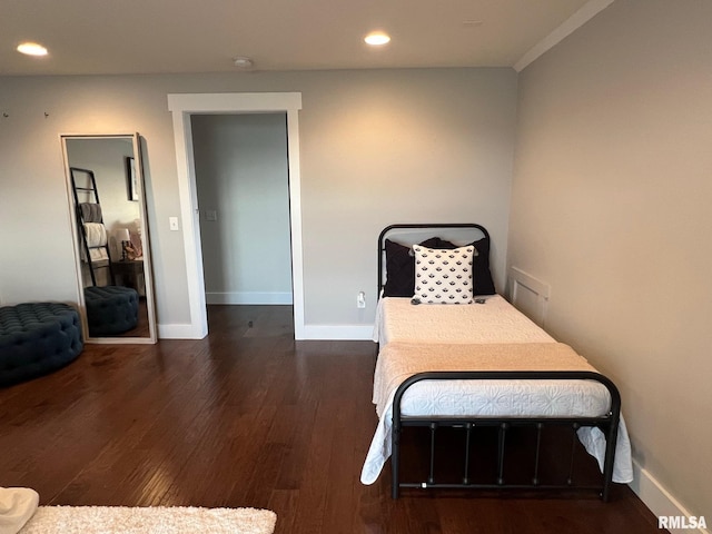 bedroom with baseboards, wood finished floors, and recessed lighting