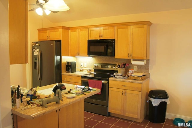 kitchen featuring light countertops, stainless steel appliances, backsplash, and dark tile patterned flooring