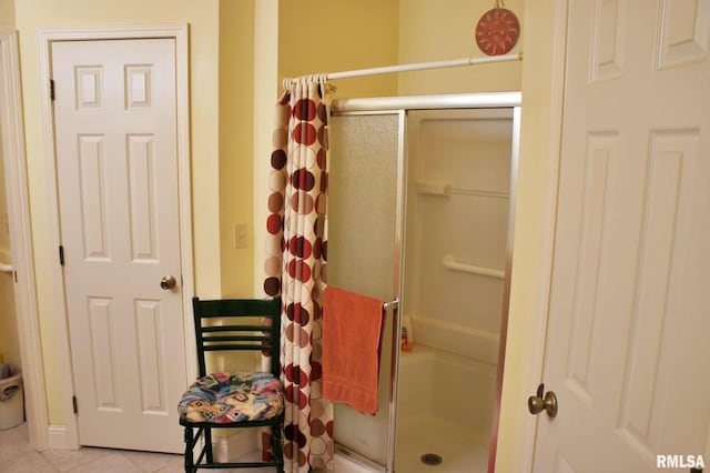 full bathroom featuring a stall shower and tile patterned flooring