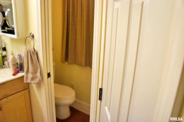 bathroom featuring vanity and toilet