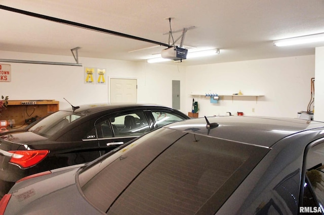 garage featuring electric panel and a garage door opener