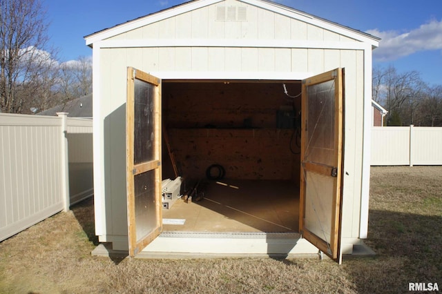 view of shed featuring fence