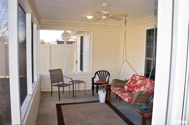 sunroom featuring a ceiling fan