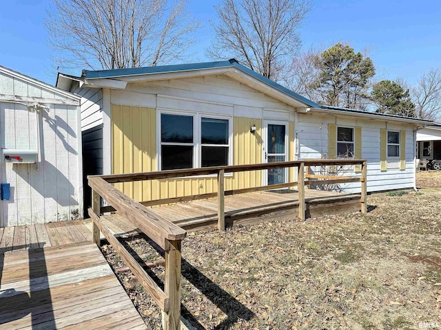 rear view of house with a wooden deck