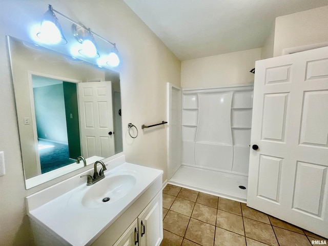 full bath with tile patterned flooring, walk in shower, and vanity