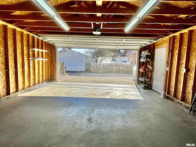 garage with a shed and a garage door opener