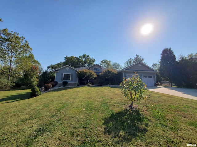 view of front of house featuring a front lawn, concrete driveway, and a garage