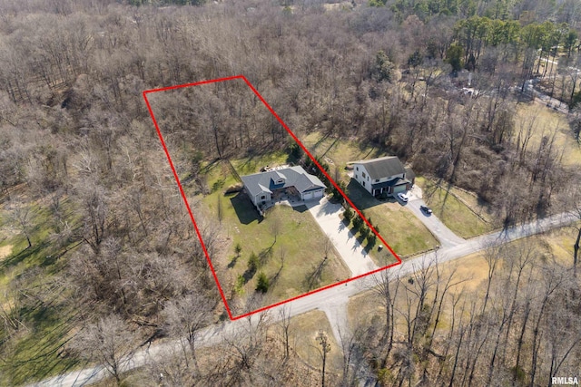 birds eye view of property with a view of trees