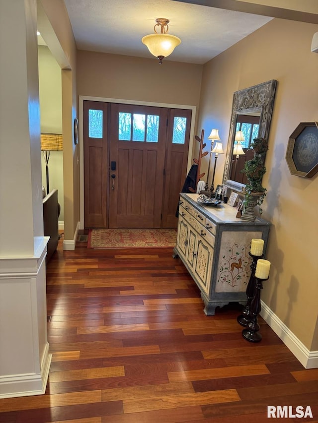 entrance foyer featuring baseboards and hardwood / wood-style flooring