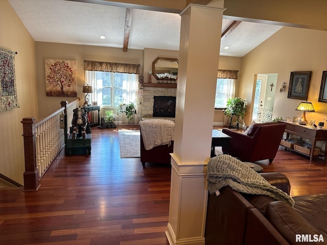 living area with dark wood finished floors, lofted ceiling with beams, and plenty of natural light