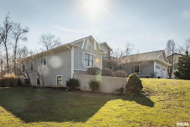 view of property exterior featuring a yard and a garage