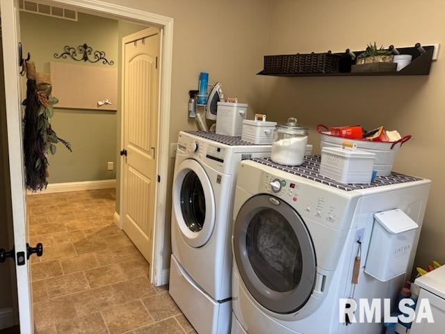 laundry room featuring laundry area, separate washer and dryer, visible vents, and baseboards