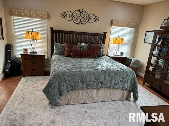 bedroom featuring baseboards and wood finished floors