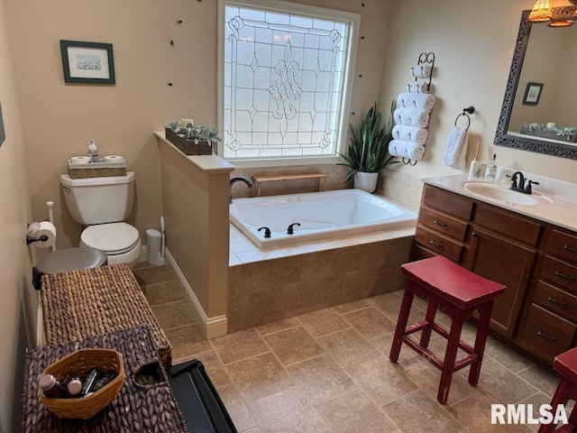 bathroom with a bath, toilet, and vanity