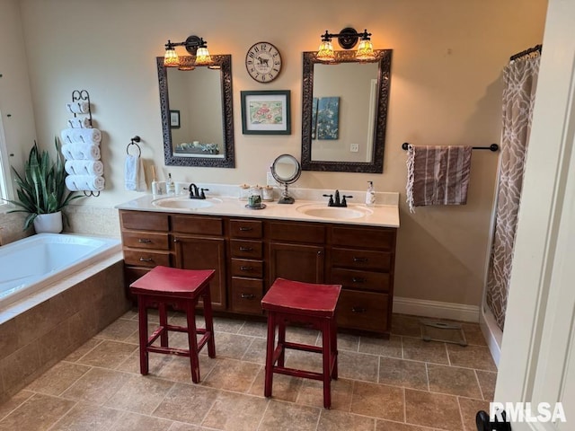 bathroom with a sink, a relaxing tiled tub, baseboards, and double vanity