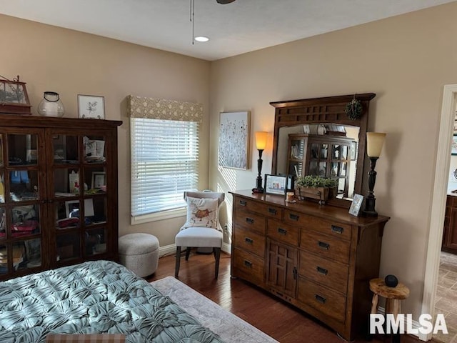 bedroom with baseboards and wood finished floors