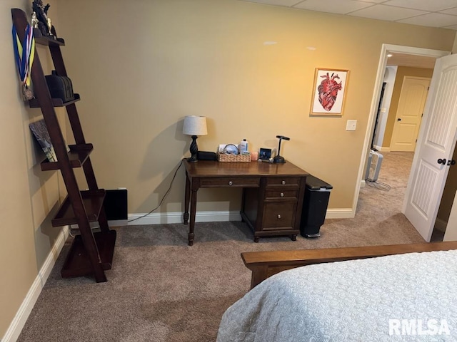 bedroom with a paneled ceiling, baseboards, and light carpet