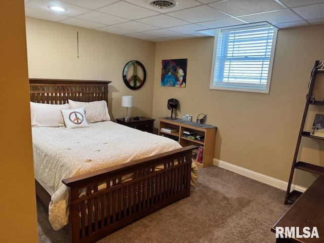 carpeted bedroom featuring visible vents, a paneled ceiling, and baseboards