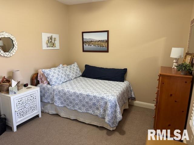 bedroom featuring carpet flooring and baseboards