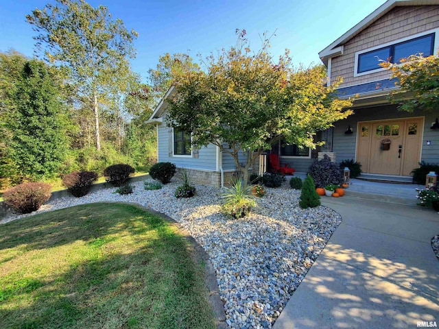 view of front of house with stone siding and a front yard