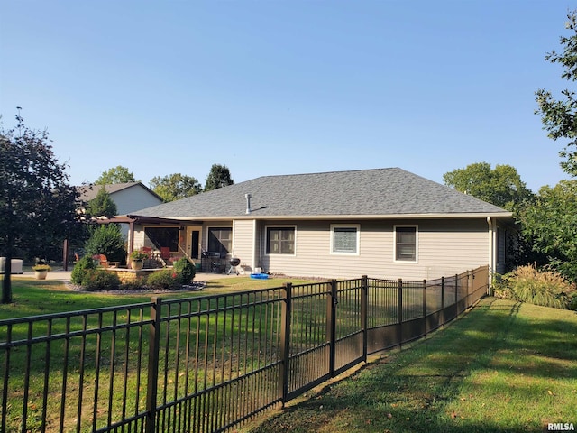 rear view of property featuring a yard, a patio, a fenced backyard, and a shingled roof