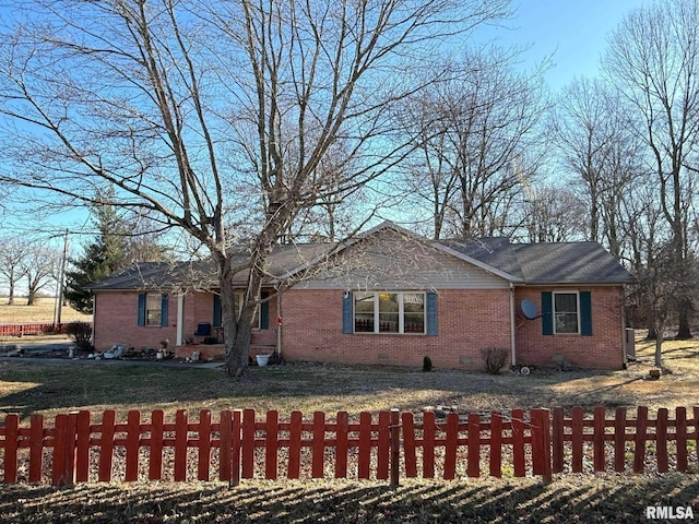 ranch-style house with a fenced front yard, a front yard, crawl space, and brick siding