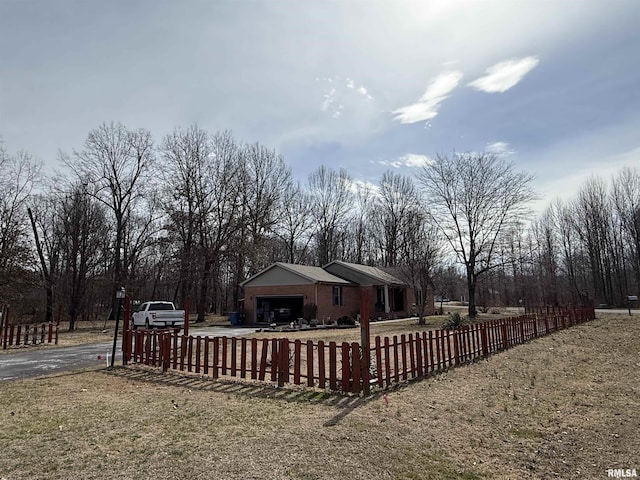 view of yard with an attached garage and a fenced front yard