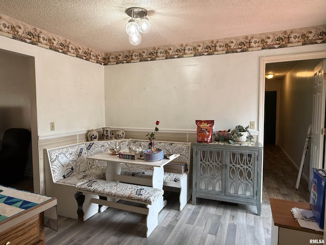 sitting room with a textured ceiling and wood finished floors