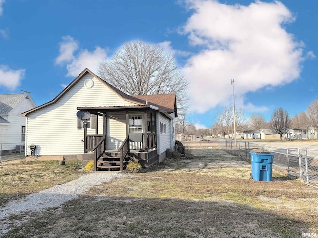 bungalow-style house with a porch and fence