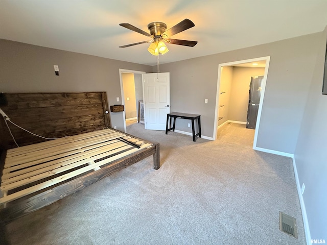 carpeted bedroom with visible vents, ceiling fan, and baseboards