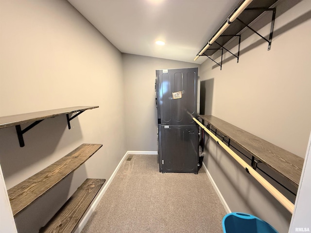 walk in closet featuring carpet floors and vaulted ceiling
