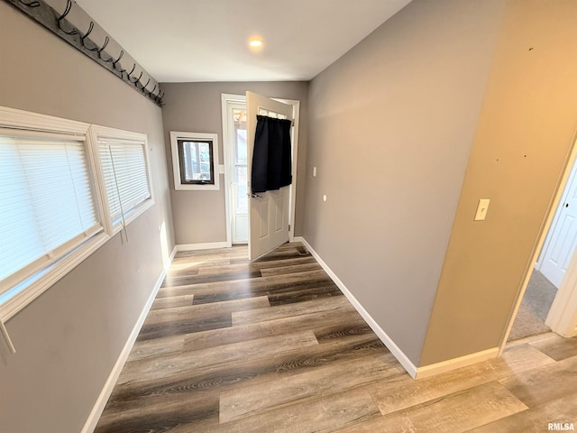 interior space featuring baseboards and wood finished floors