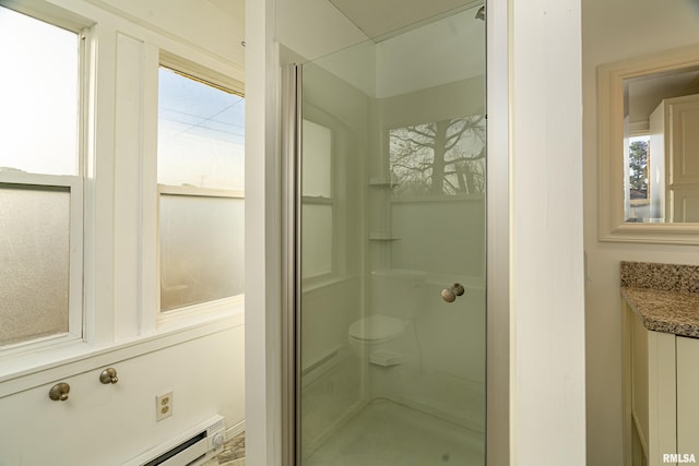 full bath featuring a healthy amount of sunlight, a baseboard heating unit, and a walk in shower