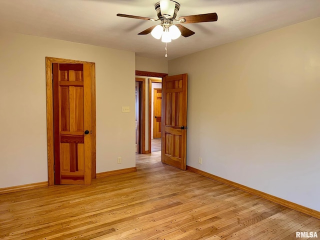 empty room with light wood-style floors and baseboards