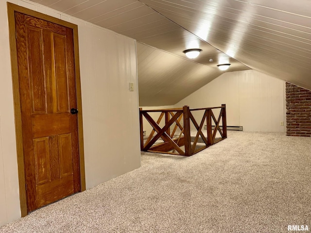 additional living space featuring carpet flooring, vaulted ceiling, and wood walls