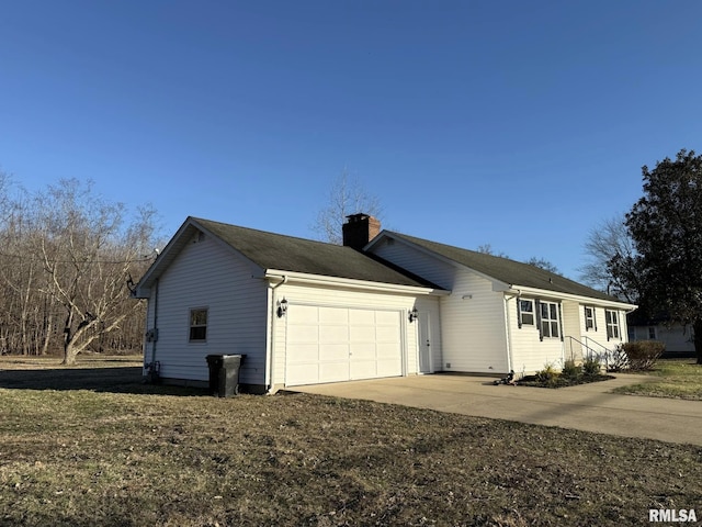 view of home's exterior with concrete driveway, a chimney, and an attached garage