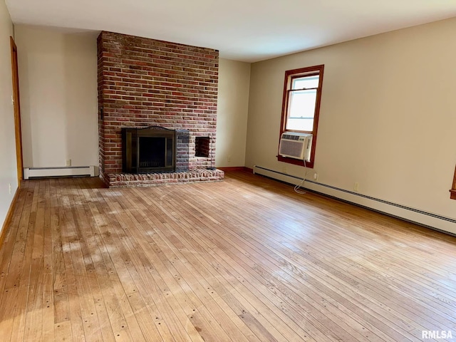 unfurnished living room with a brick fireplace, hardwood / wood-style floors, and baseboard heating