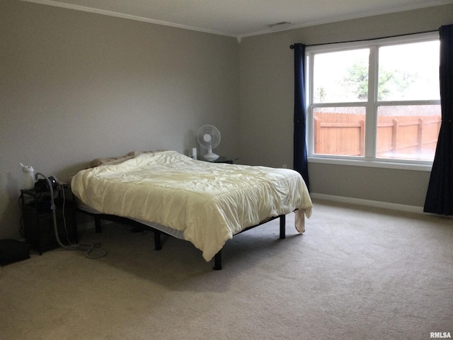 bedroom with baseboards, multiple windows, carpet, and crown molding