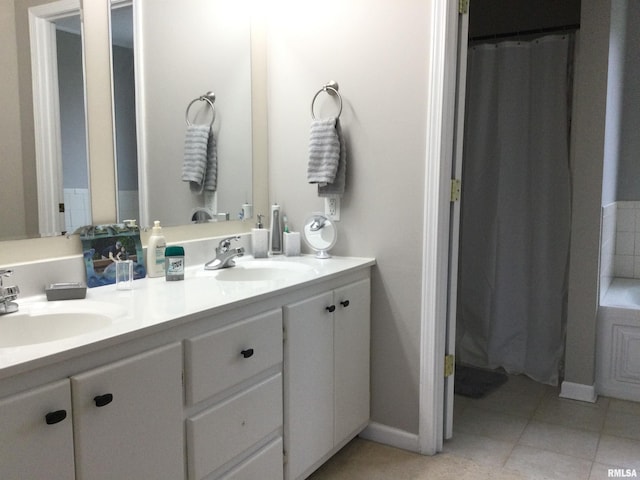 full bathroom featuring double vanity, a shower with curtain, a sink, and tile patterned floors